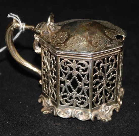 A Victorian silver mustard, with foliate-pierced octagonal body, engraved cover and green glass liner,